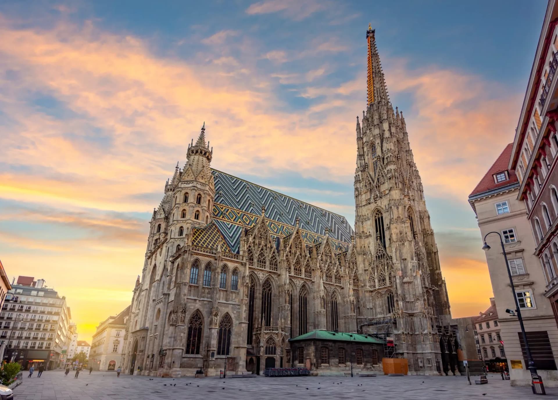 St. Stephen's Cathedral with colorful tiled roof at sunset in Vienna city square