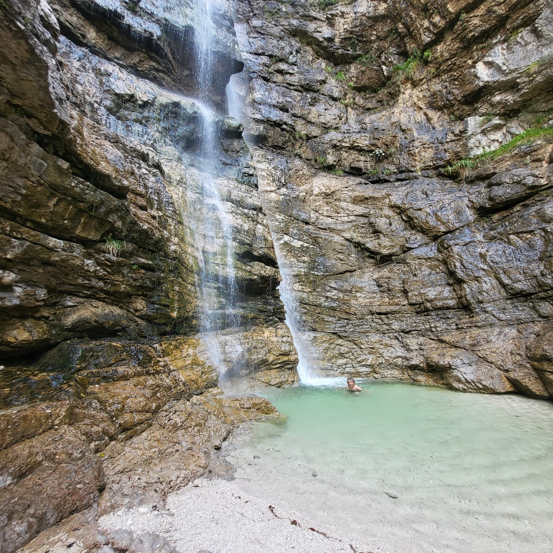 Waterfall cascading over rocky cliffs into a turquoise pool