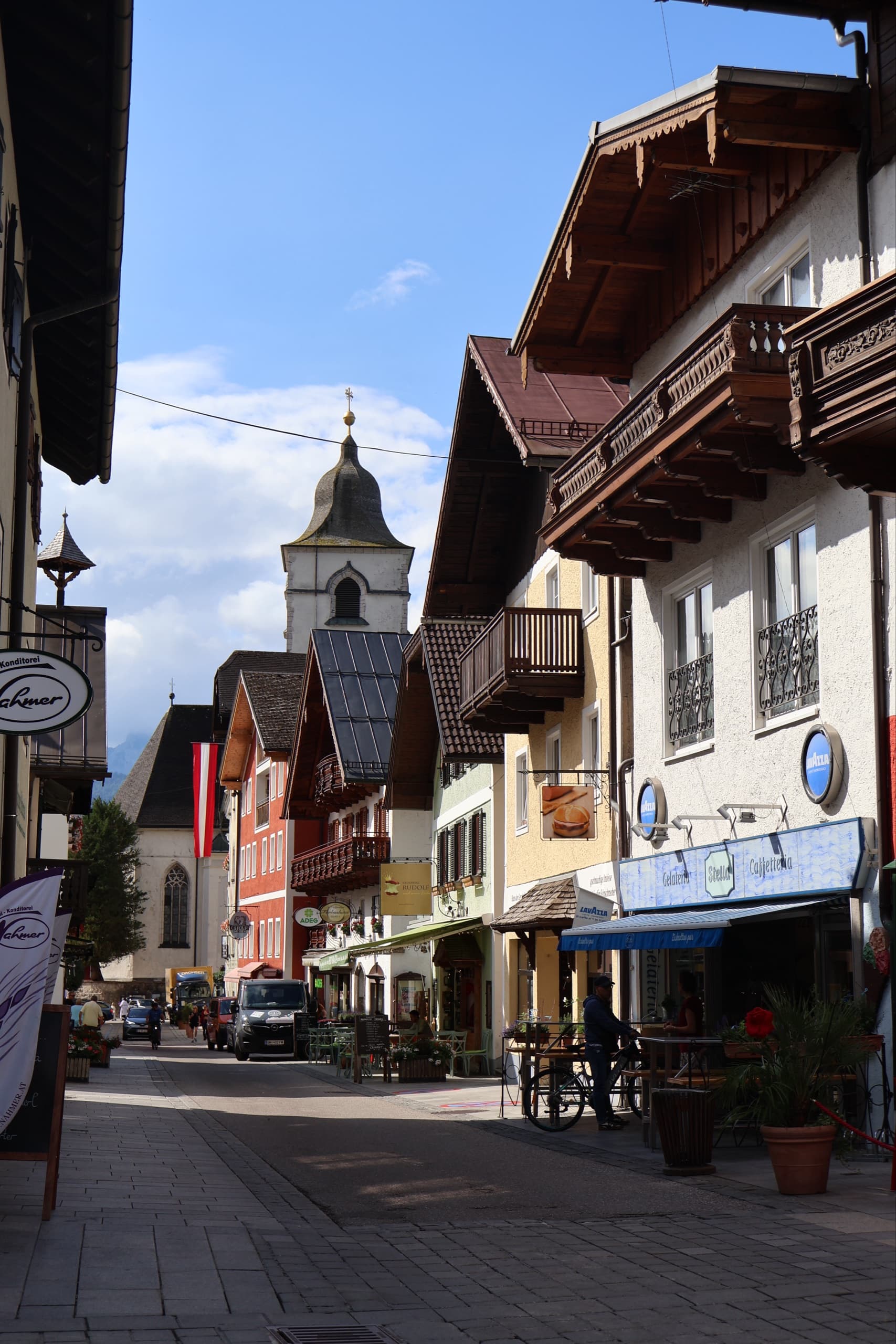 St. Wolfgang historic old town street with traditional alpine buildings and church tower