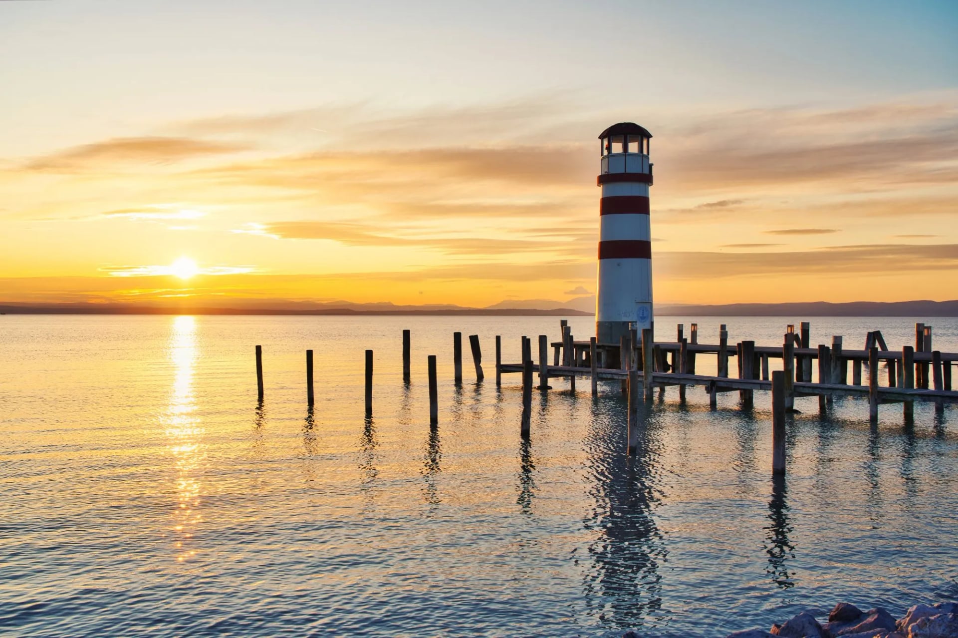 Scenic sunset at idyllic lake Neusiedlersee with old Podersdorf Leuchtturm lighthouse, Burgenland, Austria