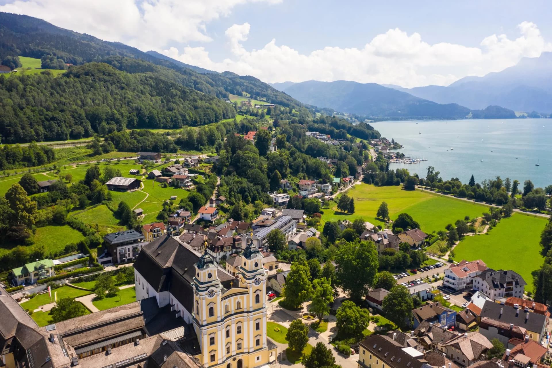 Aerial of Mondsee village with Basilika saint Michael on the lake, Mondsee, Upper Austria, Austria