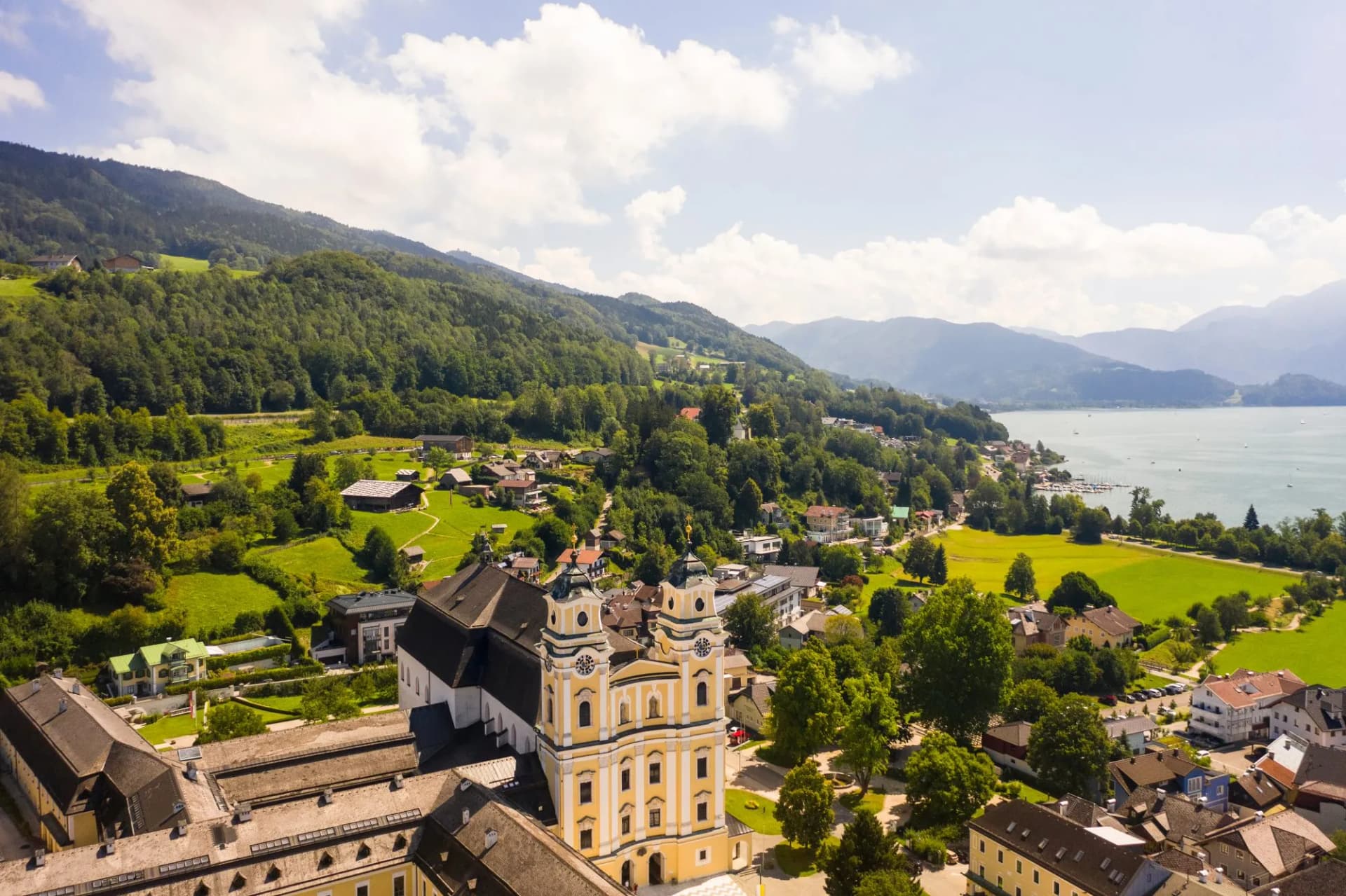 Aerial of Mondsee village with Basilika saint Michael on the lake, Mondsee, Upper Austria, Austria