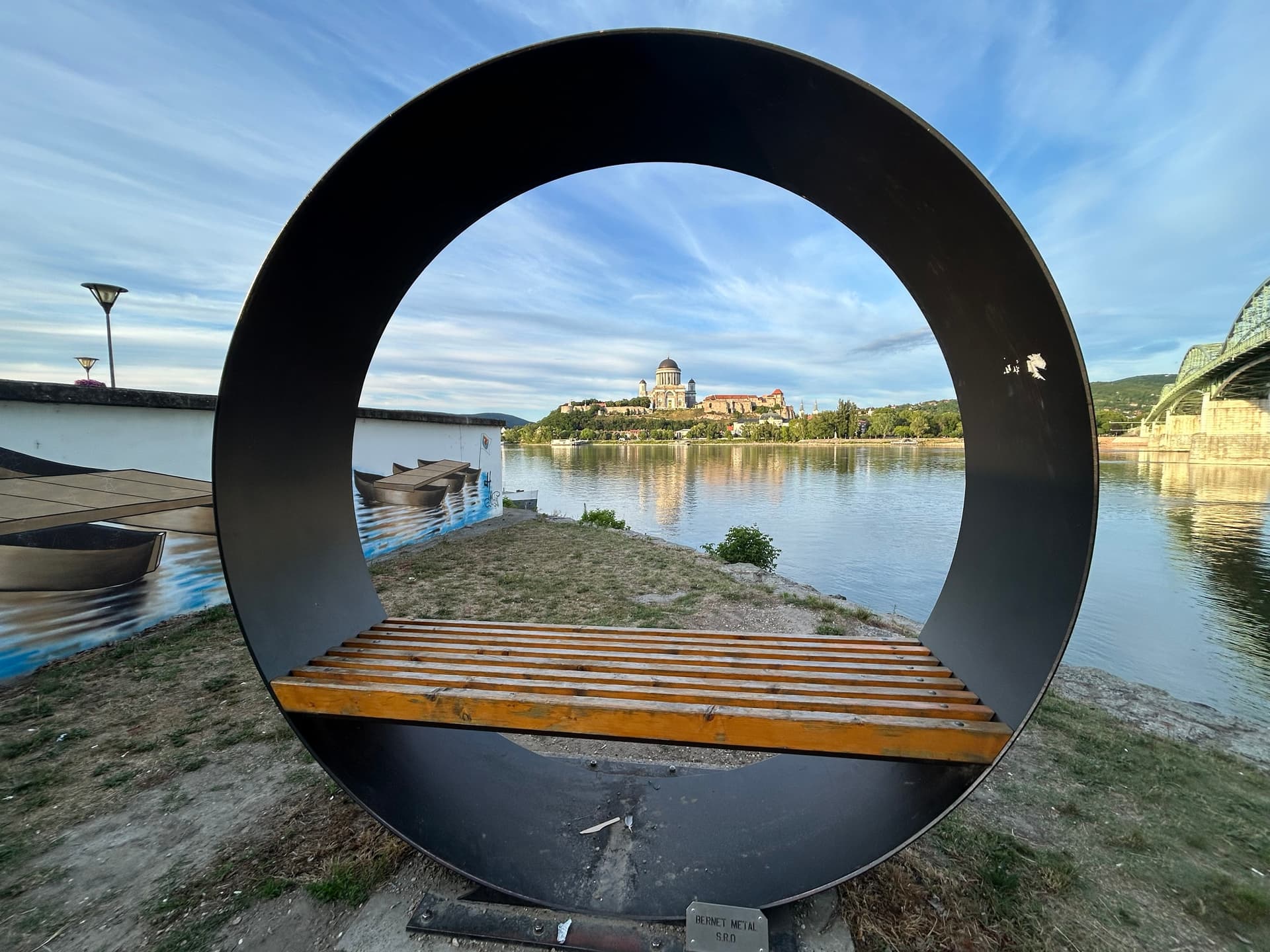 Esztergom Basilica viewed through a circular metal sculpture framing the river landscape